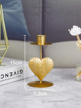 Load image into Gallery viewer, '1pc Heart Design Candle Holder' - this elegant article provide a secure and safe base for candles to avoid any mishaps. This gold coloured candle holder will make the environment stylish and will add a romanticism touch to any environment!      Colour: Gold     Type: Candle Holder     Material: Iron     Size: Length(7.2cm/2.8inch) Width (7.2cm/2.8inch) Height (12.7cm/1.1inch)     Candle included     Gift box included     Object to be used with caution.