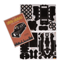 Load image into Gallery viewer, Make your own iconic London taxi with this cardboard craft kit! It comes with 37 pieces and instructions to help build the model. Model measurements are as follows:      Dimensions: Width 7cm Height 7cm Length 18cm     Material: Paper     Gift idea. British Souvenir. London Landmarks collection 3D toys.