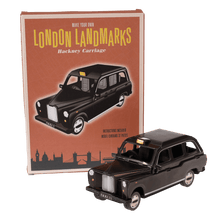 Load image into Gallery viewer, Make your own iconic London taxi with this cardboard craft kit! It comes with 37 pieces and instructions to help build the model. Model measurements are as follows:      Dimensions: Width 7cm Height 7cm Length 18cm     Material: Paper     Gift idea. British Souvenir. London Landmarks collection 3D toys.