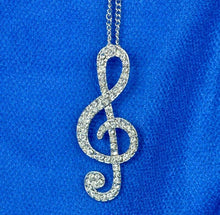 Load image into Gallery viewer, Silver colour Women Lady Crystal Silver Gold Musical Note Pendant Necklace Sweater Chain. Adorable treble clef pendant with light chain. Gift idea for musicians and music lovers. 100% Brand New Material: Alloy + Crystal Color: Silver (last available) Pendant size: About 5.5 x 2cm Necklace length: Approx 62cm Quantity: 1Pcs Package includes: 1 x Music Note Necklace, mini jewel bag and charm cloth