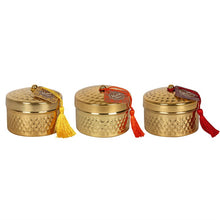 Load image into Gallery viewer, '3 pcs - Kasbah scented Candlepots with Tassle' This fragranced candle set come in a gold tone candle-pots with hammer effect texture. A coloured tassel finishes off this elegant candle. Sold in multiples of 3, one of each fragrance: red tassel is Sandalwood, orange is Morning Blossom and yellow is Jasmine. Give an elegant oriental style to your home with these decorative candles'.      Size: H 10cm x W 11.99cm x D 8cm     Weight: 30g each     Gift box included