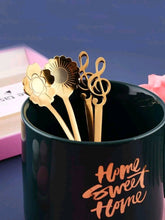 Load image into Gallery viewer,  '4 pcs of this adorable music spoon set with floral design! Match it with other Rovistella's item such as the espresso cups and make your guests surprised by the beauty of this set!'      Colour: Gold     Pattern Type: Floral/Music     Type: Spoon     Material: Stainless Steel (dry it well after washing by hand)     Size: Length 13.5 cm (5.3 inch) X Width 2.8cm (1.1inch)