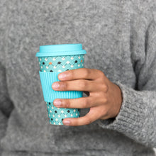 Load image into Gallery viewer, This eco-friendly travel mug comes in a bold Atomic Blue design, and is made from bamboo fibre. Complete with a silicone lid and sleeve to prevent spillages and protect hands.