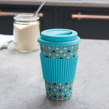 Load image into Gallery viewer, This eco-friendly travel mug comes in a bold Atomic Blue design, and is made from bamboo fibre. Complete with a silicone lid and sleeve to prevent spillages and protect hands.