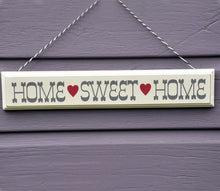 Load image into Gallery viewer, 'Rustic Wooden Home Sweet Home Sign' There's no place like home! Rustic cream wooden wall sign with hearts on a stripey string. Sign reads:  "Home Sweet Home." Hang it on the wall of your home (in the kitchen or the dining room, for example), your guests will love it! Adorable home decor item and gift idea.