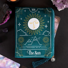 Load image into Gallery viewer, THE SUN TAROT CARD ZIPPERED BAG This velvet zipper pouch is the perfect place to keep tarot decks, crystals, beauty products and other treasures. Features a stunning white and gold sun tarot card illustration on the front and a matching tassel and gold sun charm on the zipper. Designed by Something Different and part of The Fortune Teller range of mystical gifts and home decor. Fabric and Polyester Height 15cm x Width 20cm x Diameter 0.75cm