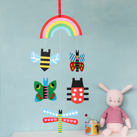 'If you are looking for a colourful way to decorate the children's cots, this cardboard 'bugs' baby mobile with high contrast colours, exclusive design (with butterflies, bees and lady birds), will add a lovely touch of sweetness to your kid's room!'      Includes hanging ribbon     Length (inc. ribbon): 48cm     Width (widest point): 15cm     Caution: Choking hazard. Hang this mobile out of the reach of children. This item is a decoration, not a toy.