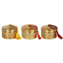Load image into Gallery viewer, &#39;3 pcs - Kasbah scented Candlepots with Tassle&#39; This fragranced candle set come in a gold tone candle-pots with hammer effect texture. A coloured tassel finishes off this elegant candle. Sold in multiples of 3, one of each fragrance: red tassel is Sandalwood, orange is Morning Blossom and yellow is Jasmine. Give an elegant oriental style to your home with these decorative candles&#39;.      Size: H 10cm x W 11.99cm x D 8cm     Weight: 30g each     Gift box included
