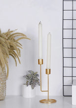 Load image into Gallery viewer, &#39;Double-mouthed gold candlestick&#39; This elegant candle holder is perfect for embellishing saloons, kitchen table and desks daily or in special celebrations. Largely used to make the atmosphere refined and romantic. Article in high demand and well publicized on the current magazines of home décor!&#39;      Colour: Gold     Size: Height 24cm Width 10cm     Material: Metallic     Candles included
