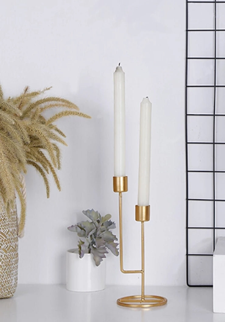 'Double-mouthed gold candlestick' This elegant candle holder is perfect for embellishing saloons, kitchen table and desks daily or in special celebrations. Largely used to make the atmosphere refined and romantic. Article in high demand and well publicized on the current magazines of home décor!'      Colour: Gold     Size: Height 24cm Width 10cm     Material: Metallic     Candles included