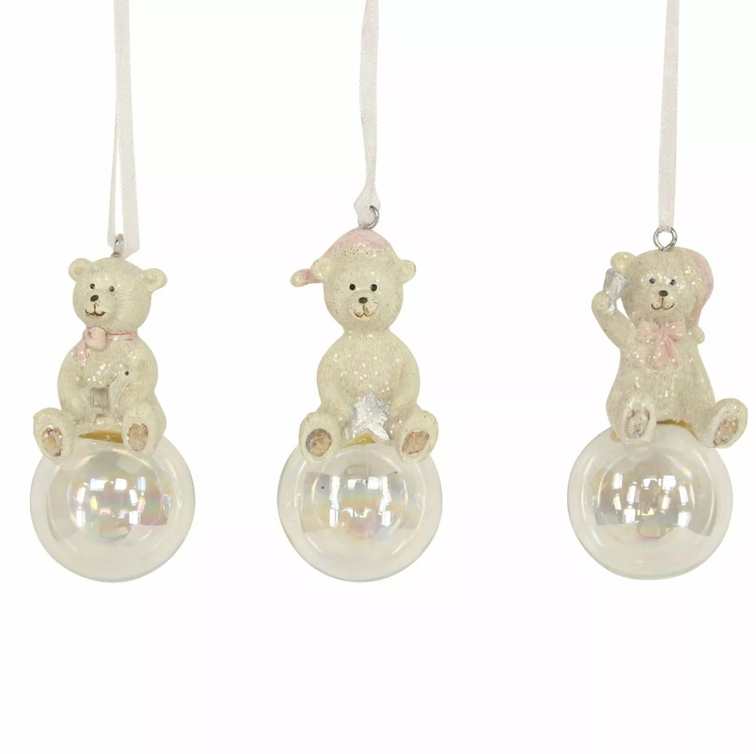 Set of 3 Resin Decorations 9 cm - Teddies on Glass Bubbles      Set of three teddy bears on glass bubbles hanging decorations     Perfect within a pink and white themed tree     8.5cm  Dimensions 8.5x4x4cm  Product Weight 21 g  Composition: 50% Resin, 50% Acrylic (item FRAGILE)