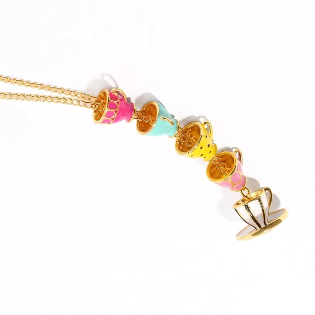 Beautifully colorful this fashion necklace has a pendant with cups stacked on top of each other, make you remember the scene from the Alice In Wonderland cartoon at the time of the Tea party with the beautifully decorated table of cup sets. An imaginative and elegant designed item to wear at a Tea room appointment or during an afternoon tea with your friends, they will love it!