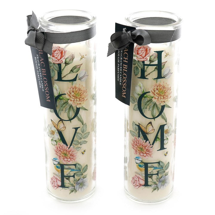 These botanical themed tube pillar candles are offered in two assorted styles - Love and Home. The minimum order quantity of two includes one of each style. The paraffin wax is fragranced with the fresh scents of Lilac Blossom (Love) or Peach Blossom (Home). This would make an ideal gift item to stock in the run up to Spring and Summer.