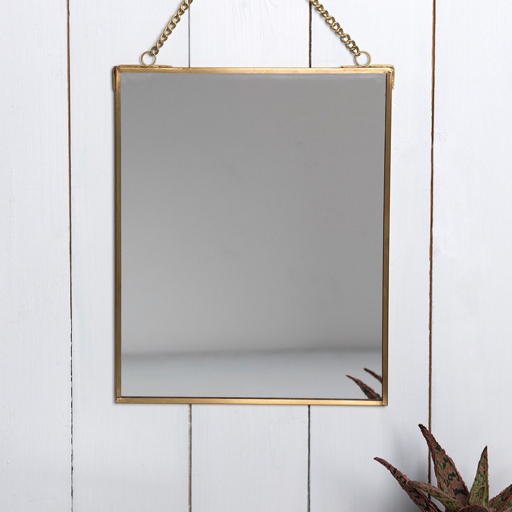  Part of the Jaipur glassware range, this gorgeous brass hanging mirror is a wonderful home decoration. It will add a touch of elegance to any environment.      Mirror measures 20x25cm     Mirror length including chain: 34.5cm     Material: Glass, Brass     Dimensions: Length: 0.5 cm Height: 25 cm Width: 20 cm 