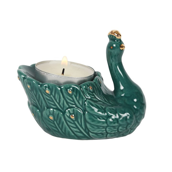 PEACOCK CERAMIC TEALIGHT HOLDER - A pretty green decorative tealight holder in the shape of a Peacock. Lovely centerpiece, gift decor ideas.      Home decor, candle holder, gift ideas emerald green and gold     Material: Ceramic     Dimensions: H7cm x W9cm x D6cm Weight: 103gr     Candles included