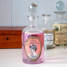 Load image into Gallery viewer, Give your bathroom a vintage feel with our apothecary perfume bottle with round glass stopper and french label. You can use it to store lotions and potions, or leave it as a decoration to give the room some Victorian character. Volume: 300ml, Material: Glass, Height: 18 cm
