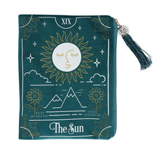 Load image into Gallery viewer, THE SUN TAROT CARD ZIPPERED BAG This velvet zipper pouch is the perfect place to keep tarot decks, crystals, beauty products and other treasures. Features a stunning white and gold sun tarot card illustration on the front and a matching tassel and gold sun charm on the zipper. Designed by Something Different and part of The Fortune Teller range of mystical gifts and home decor. Fabric and Polyester  Height 15cm x Width 20cm x Diameter 0.75cm
